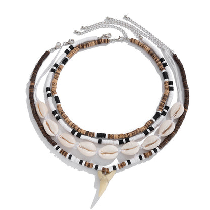 Four strand necklace set flat on white, lobster clasps and extender chains visible at the top