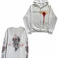 Close view of the printed bandage and red drip graphic on a white zip-up hoodie