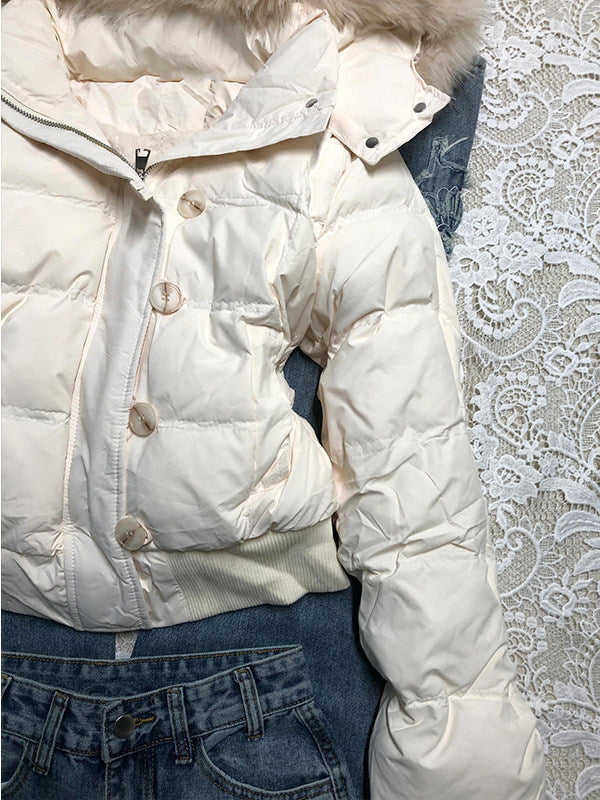White quilted jacket front with a row of buttons over the zip, a front pocket and a ribbed hem
