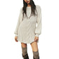 Woman in a cream cable knit mini sweater dress with long sleeves and knee high boots, studio front view