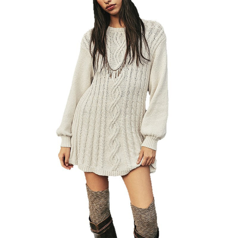 Woman in a cream cable knit mini sweater dress with long sleeves and knee high boots, studio front view