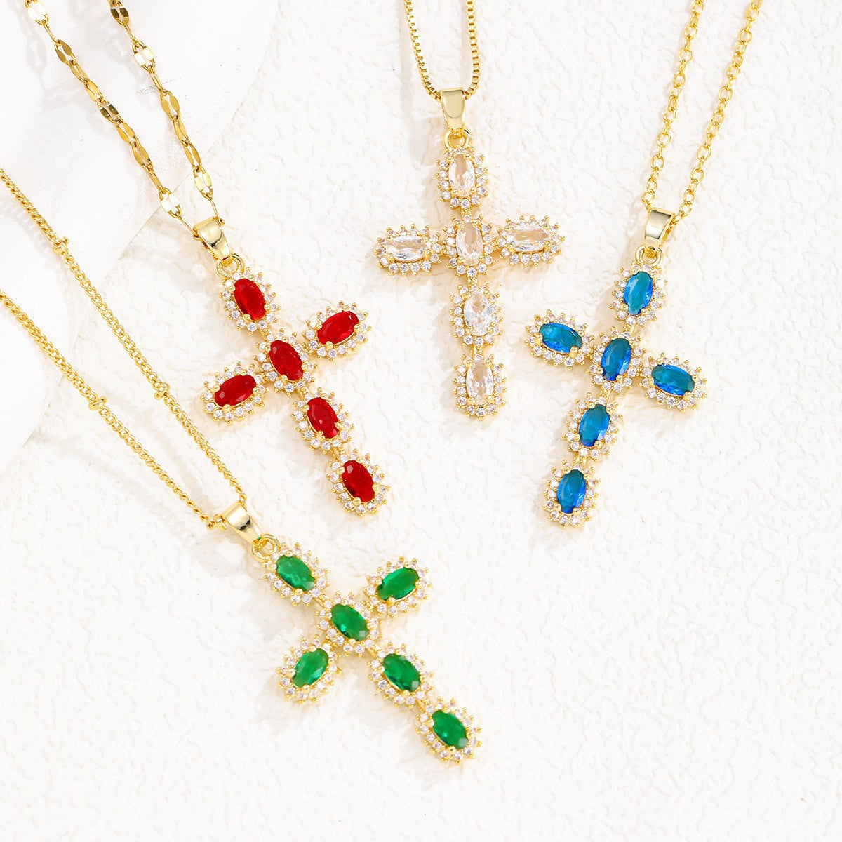 Cross pendant set with pink cubic zirconia hanging from a slim gold tone chain