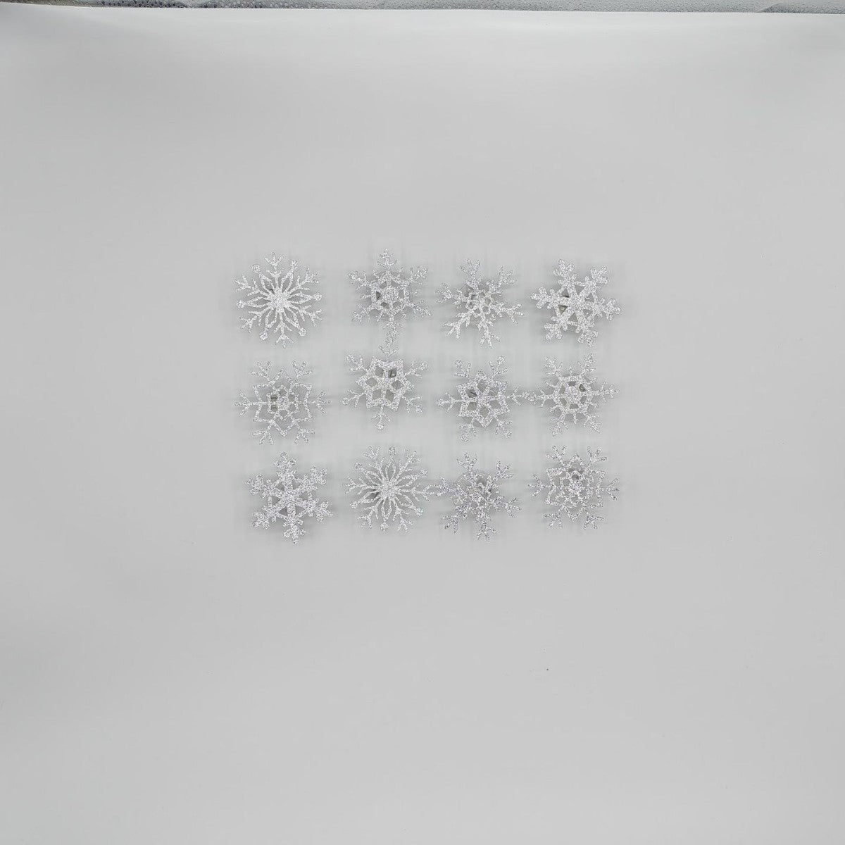 Close view of a silver glitter snowflake wall sticker with a translucent jewel tone center