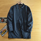Navy blue mid-length quilted lined coat with lapel collar and covered button front on a hanger, size XXL option