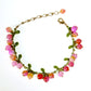 White imitation pearl berry clusters with green enamel leaves on a chain bracelet