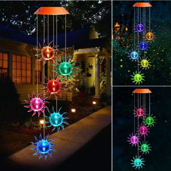 Sun LED figures glowing in several colors, hanging from a solar lamp head at night, black housing option