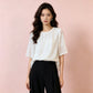 White embroidered short sleeve shirt styled with black tailored trousers