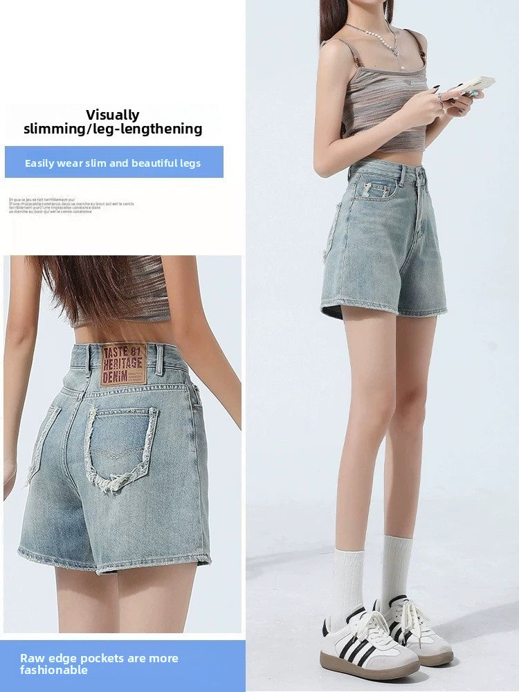 High-waisted blue denim shorts front view with button zip fly and belt loops