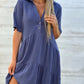 Rose pink short sleeve cotton and linen tiered shirt dress showing the gathered tiered skirt and loose fit