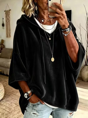 Soft hooded pullover top with three quarter sleeves worn over a white tee