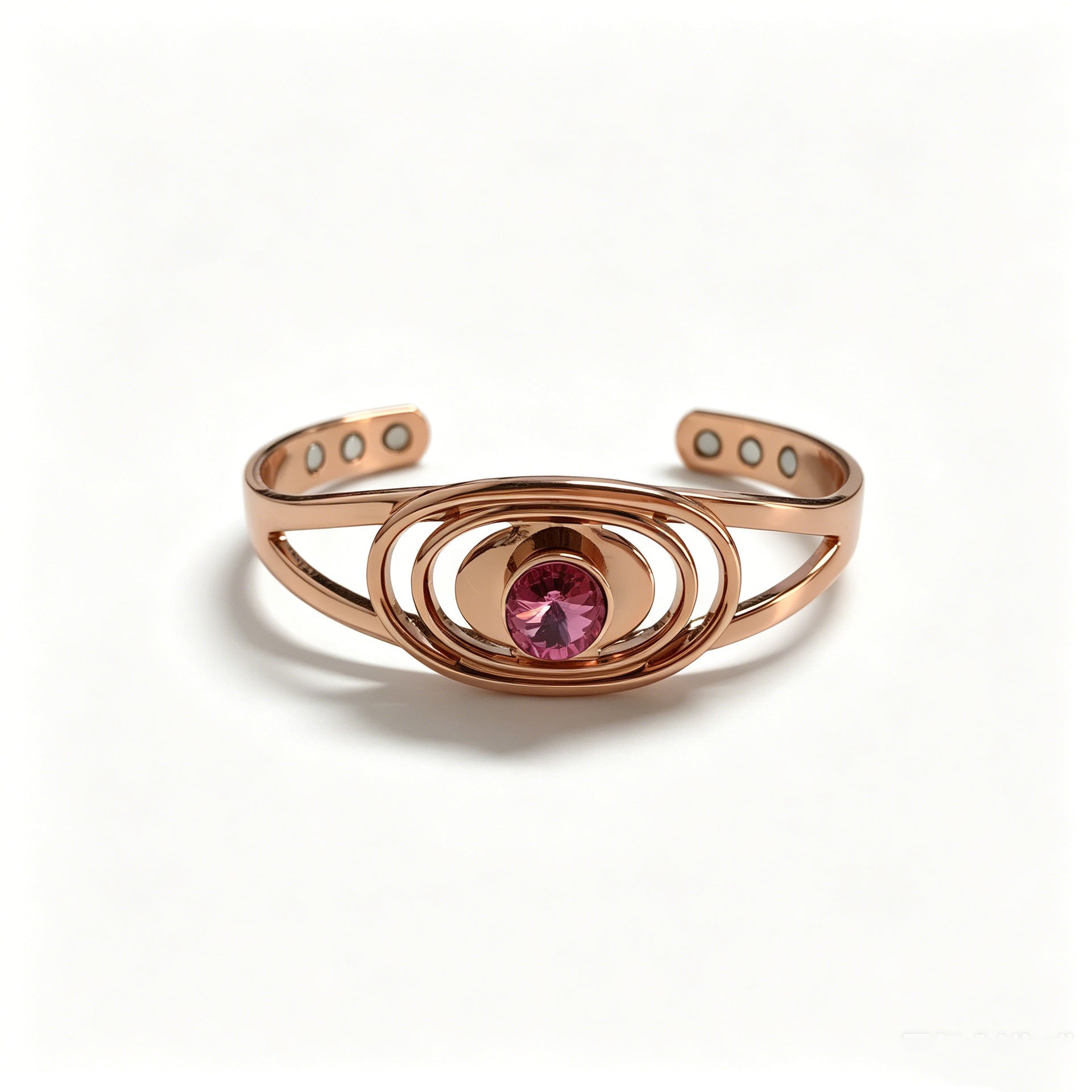 Copper cuff bracelet with faceted pink cubic zirconia and six magnets, white studio background