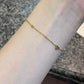 Heart bracelet styled on the wrist beside a sleeve, catching soft daylight