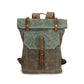 Front view of olive green and teal green canvas roll-top backpack with brown buckle strap and top handle