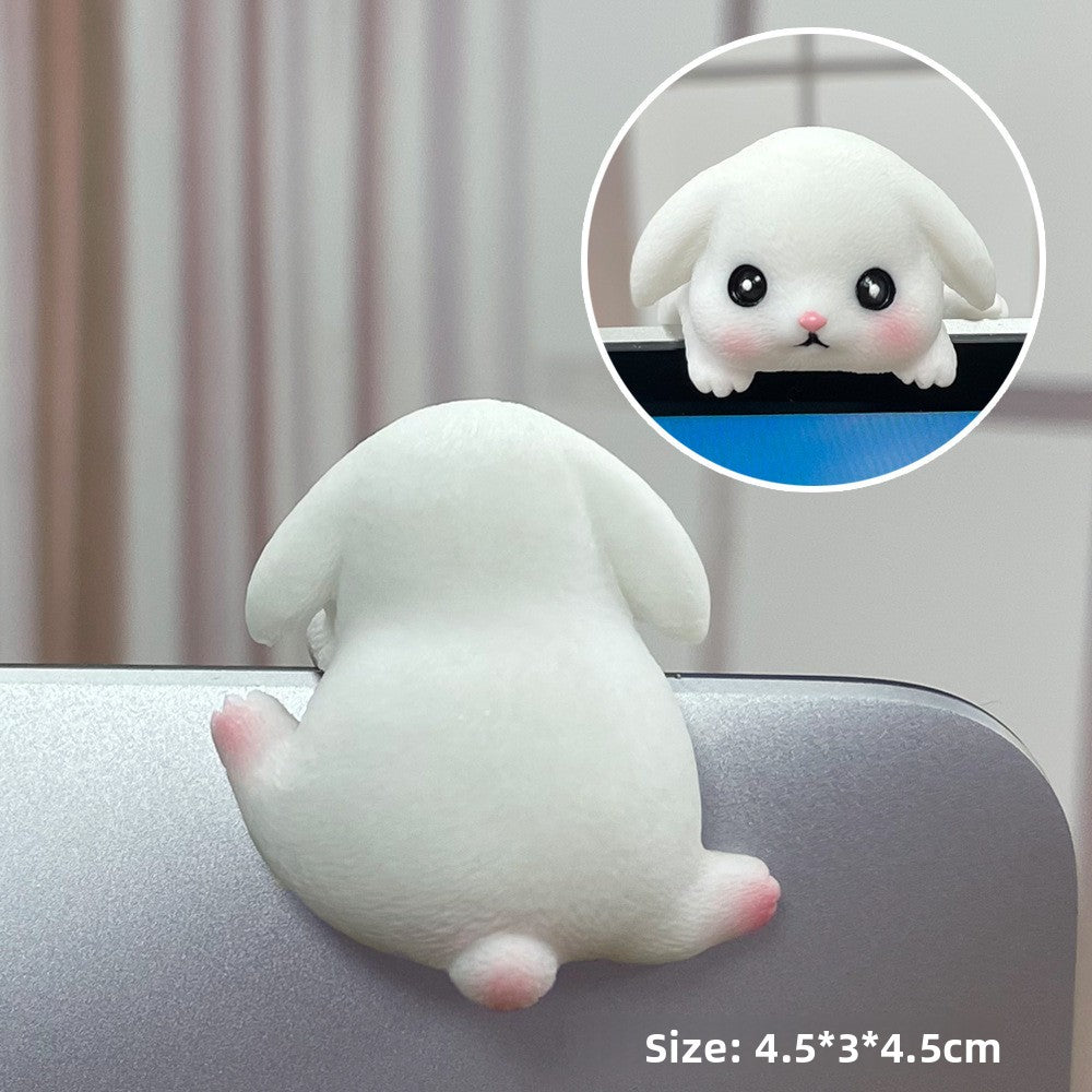 White bunny resin figurine with long ears seen from behind on a laptop edge with inset