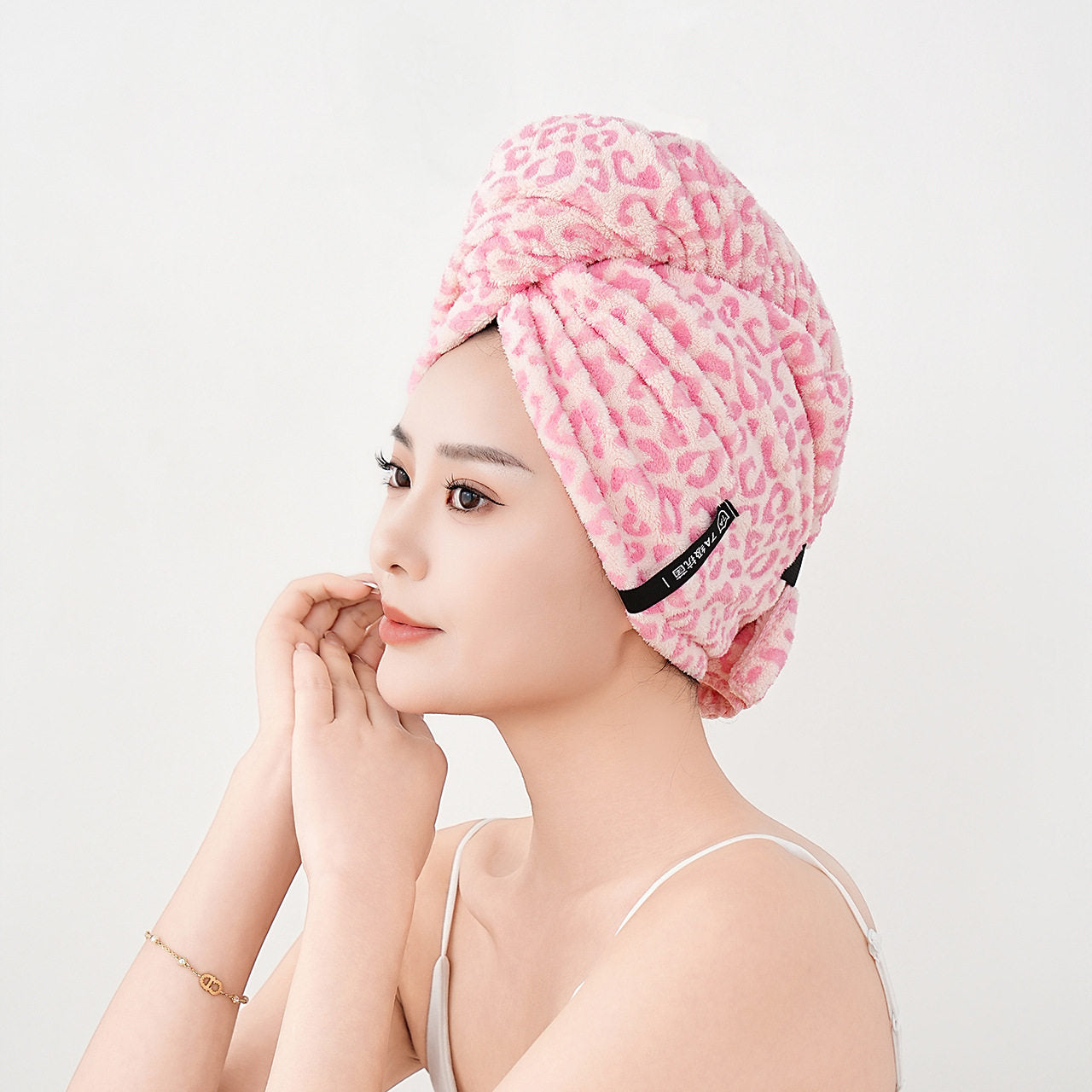 Towel hair wrap worn while drying hair during a morning bathroom routine