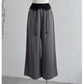 Front view of gray cotton linen wide-leg pants with black lace waistband