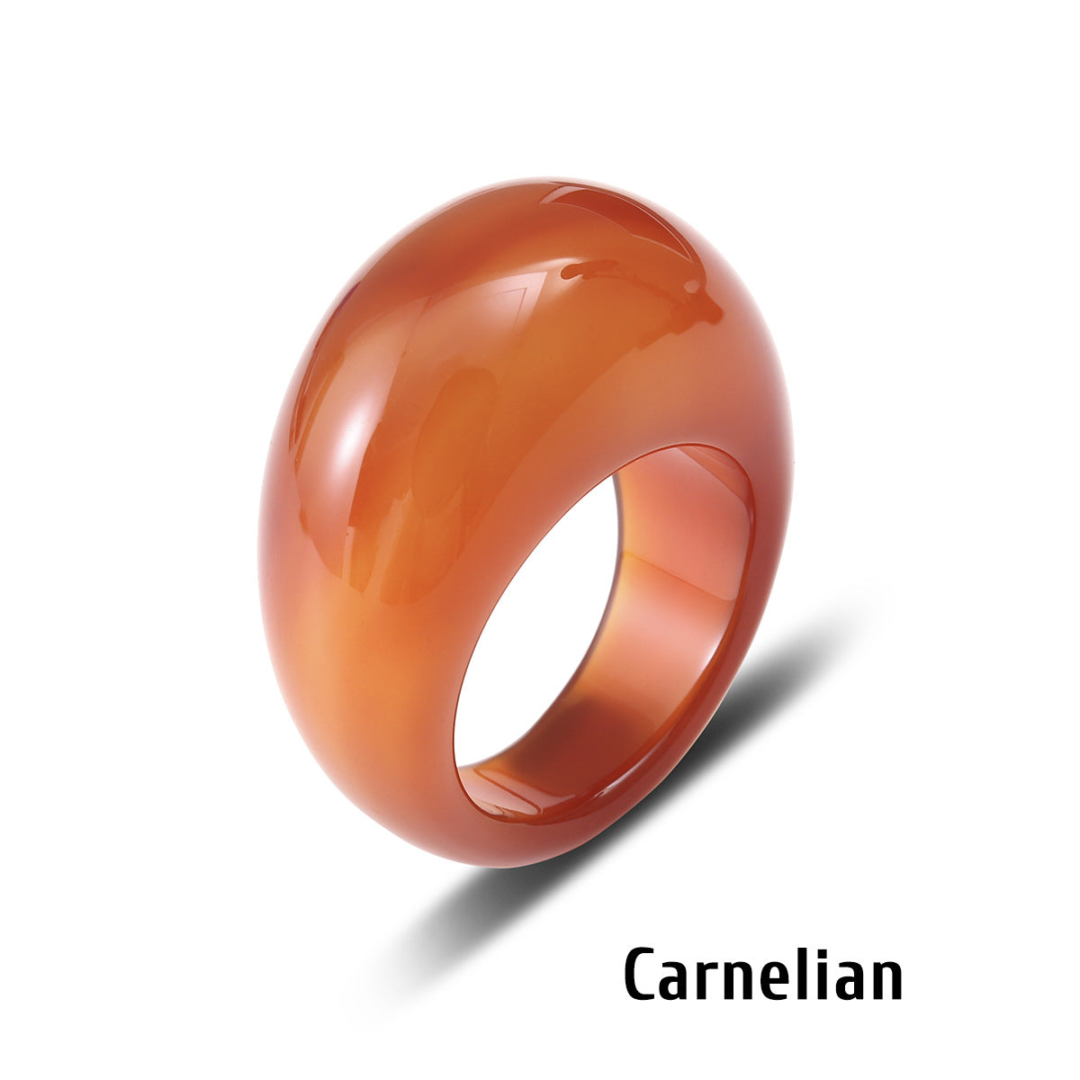 Carnelian stone ring with a domed face on a white background