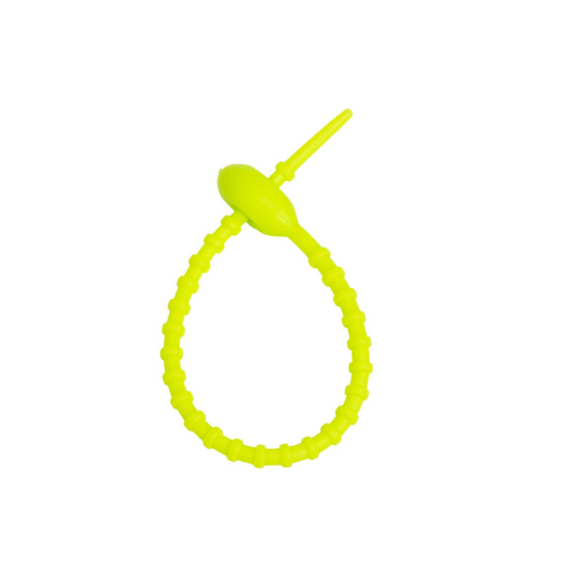 Tadpole silicone tie looped around a wrist to show how flexible the strap is