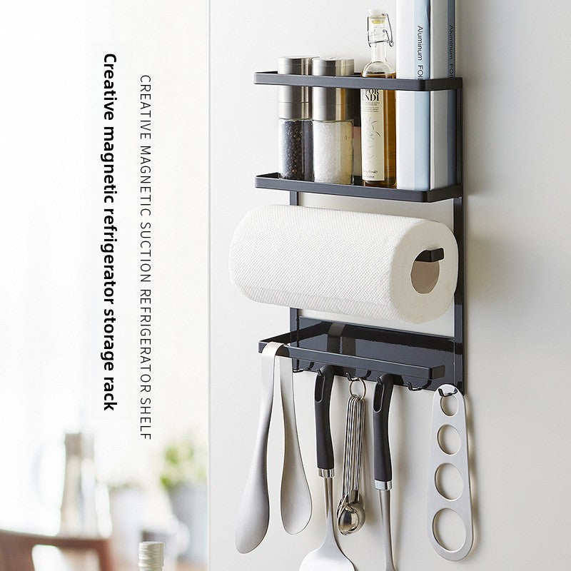 Black iron magnetic storage rack on a fridge side with a paper towel bar and utensil hooks