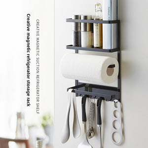 Black iron magnetic storage rack on a fridge side with a paper towel bar and utensil hooks