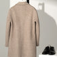Angled view of the men's herringbone wool blend overcoat on a model