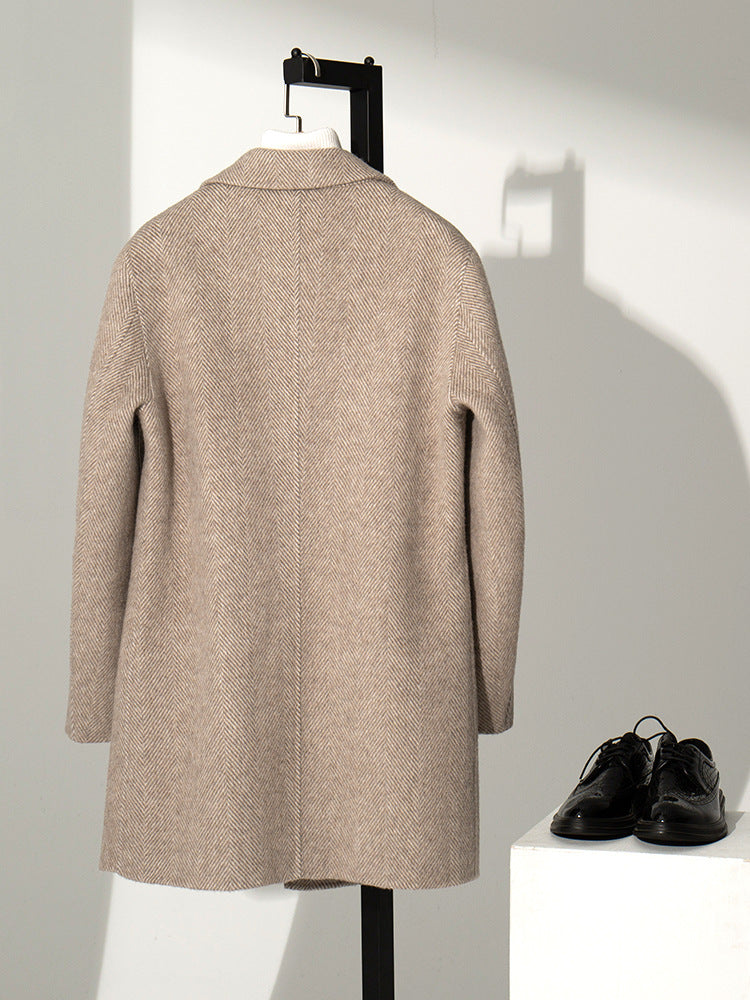 Angled view of the men's herringbone wool blend overcoat on a model