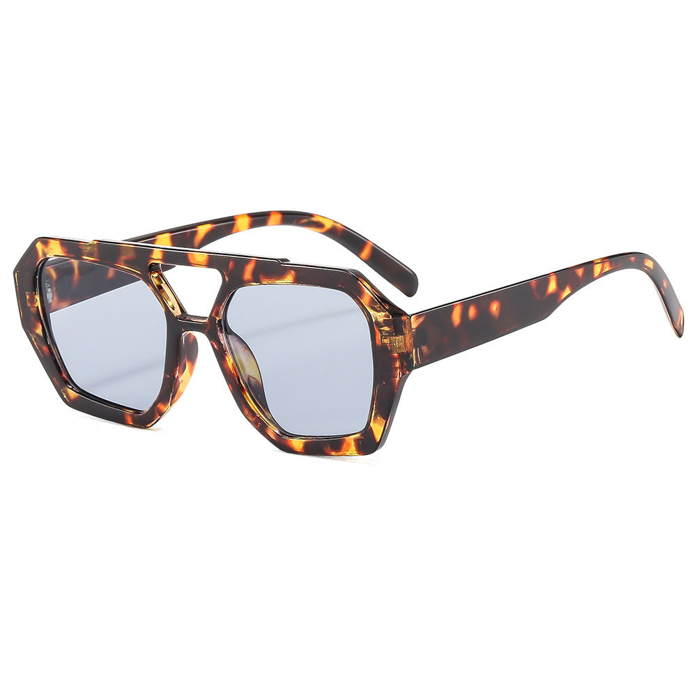 Polygonal sunglasses shown at a natural wearing angle in daylight
