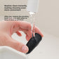 Detached grinding head being rinsed clean under running tap water by hand