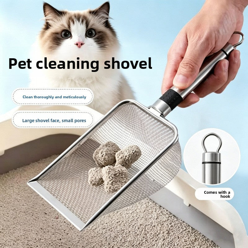White and brown cat above a hand holding a stainless steel mesh litter scoop with clumps and a handle loop close up