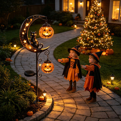 Solar iron stake light with a black cat on a starry moon and glowing pumpkin lanterns in a garden at dusk