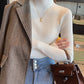 Slim fit vertical rib knit sweater with a semi high collar worn under a coat