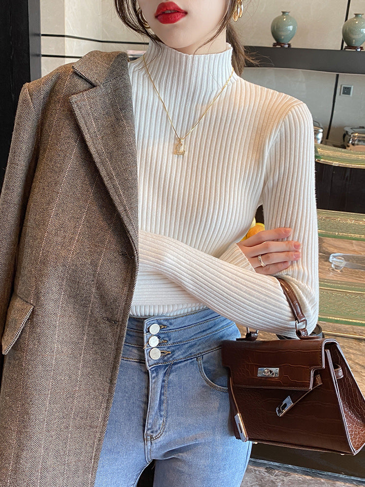 Slim fit vertical rib knit sweater with a semi high collar worn under a coat