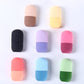 Black silicone facial ice tool laid on its side, two piece capsule join visible