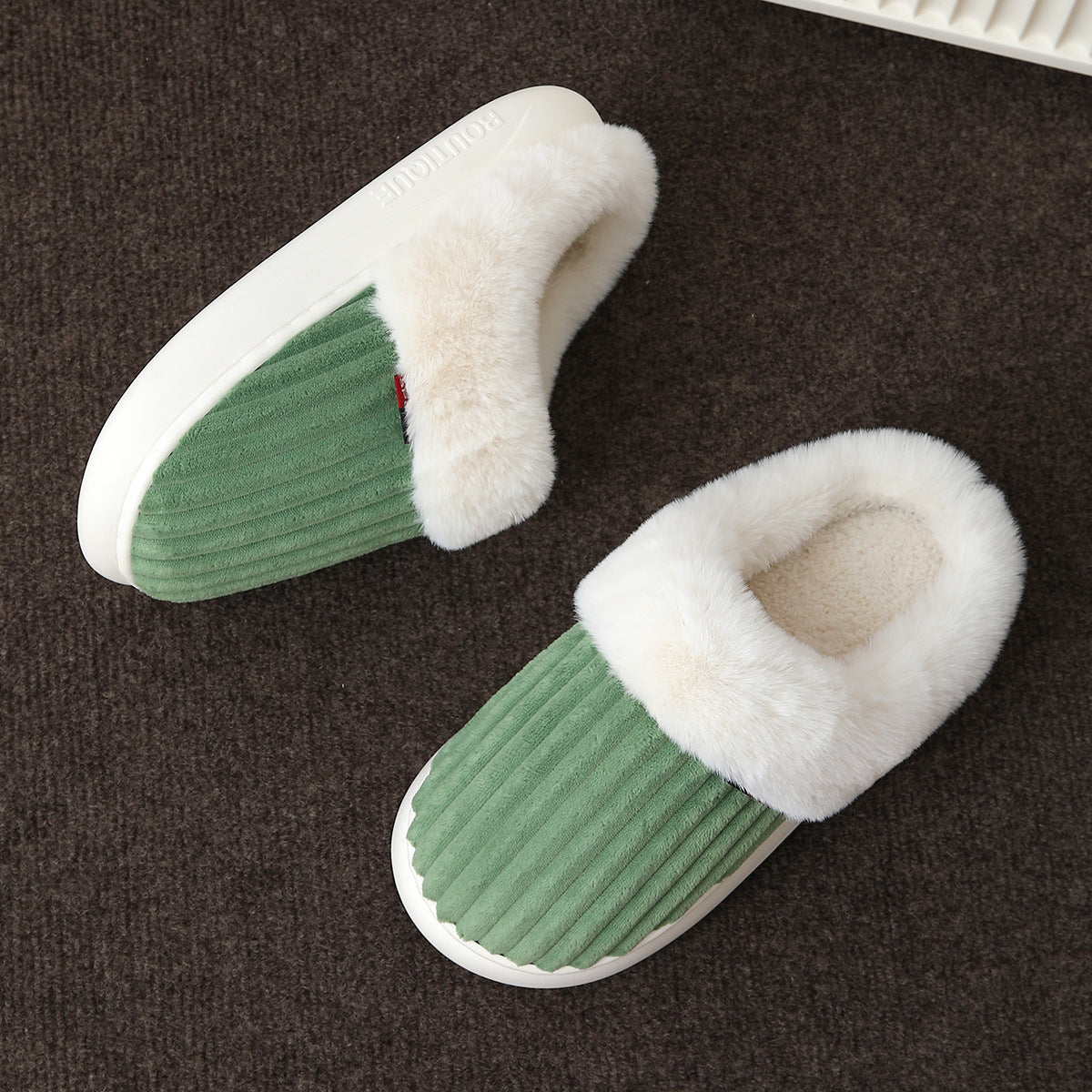 Thick moulded platform sole of the plush lined indoor mule slippers shown from the side