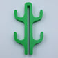Green resin four hook with four arms, seen from the front on a light background