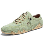 Light green microfiber low-top lace-up casual shoe with a wavy cream lug sole, three quarter view