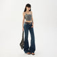 Low rise flared jeans on a model styled with a brown belt and a shoulder bag, front view