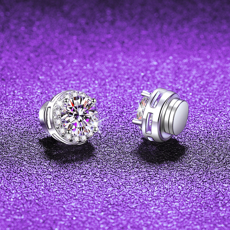 Pair of silver halo stud earrings on purple glitter, one showing the stone front and one the flat magnetic back