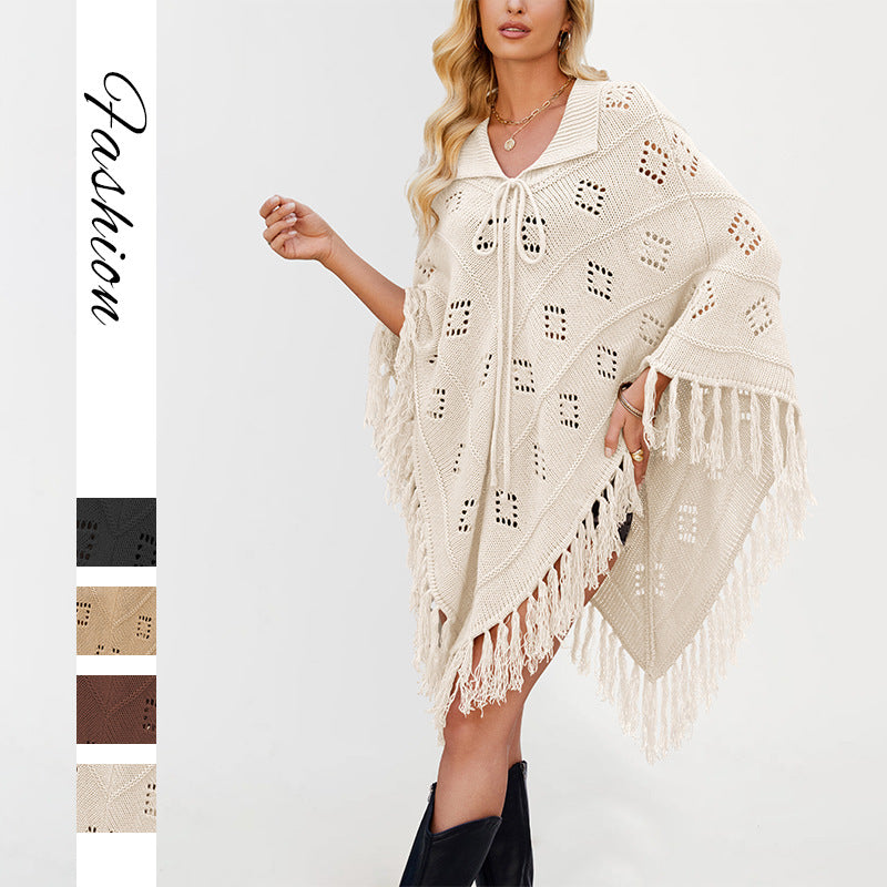 Draped knit poncho with openwork eyelet stitch, collar front tie and tassel fringe hem