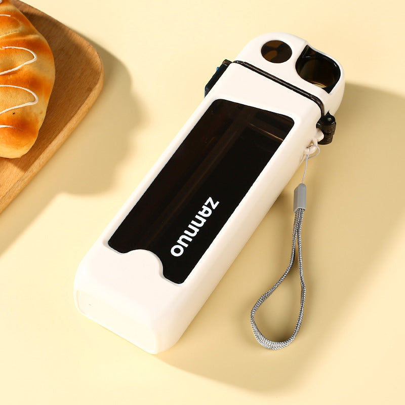 White square plastic sports water bottle lying flat with grey woven strap and flip straw lid