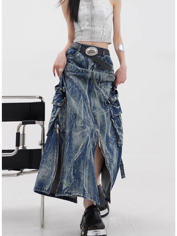 Side view of the blue acid-wash denim maxi skirt, cargo pockets and buckle straps lifting the flared hem