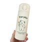 Cream insulated bottle on white, green bear drawing, flip top button visible on the collar