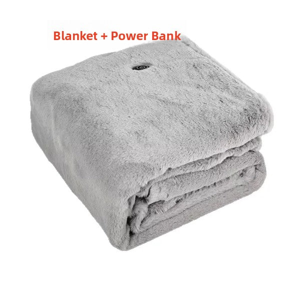 Folded gray plush heating shawl blanket under the caption Blanket + Power Bank on a white background