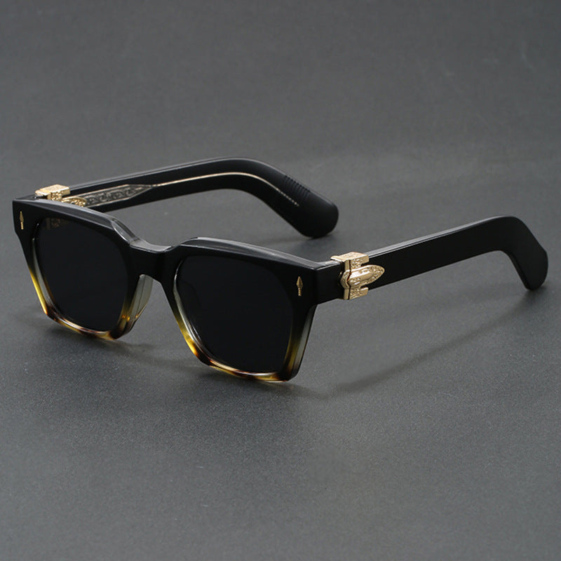 Chunky square sunglasses shown front on with tinted gradient lenses on a plain background