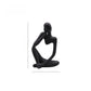 Speckled sandstone abstract resin meditator figurine in a seated contemplative pose