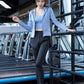 Activewear set worn during a yoga stretch on a wood floor