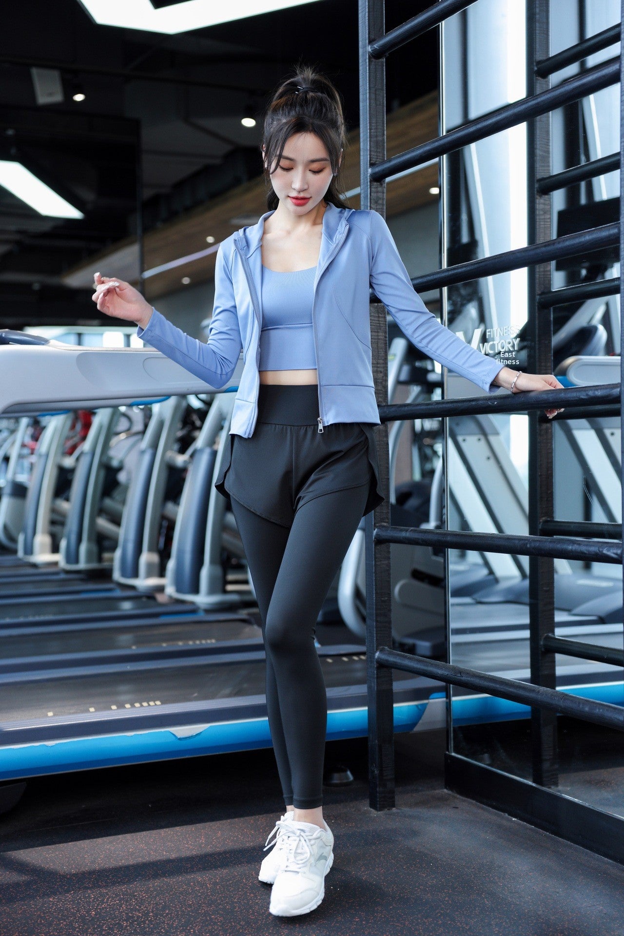 Activewear set worn during a yoga stretch on a wood floor