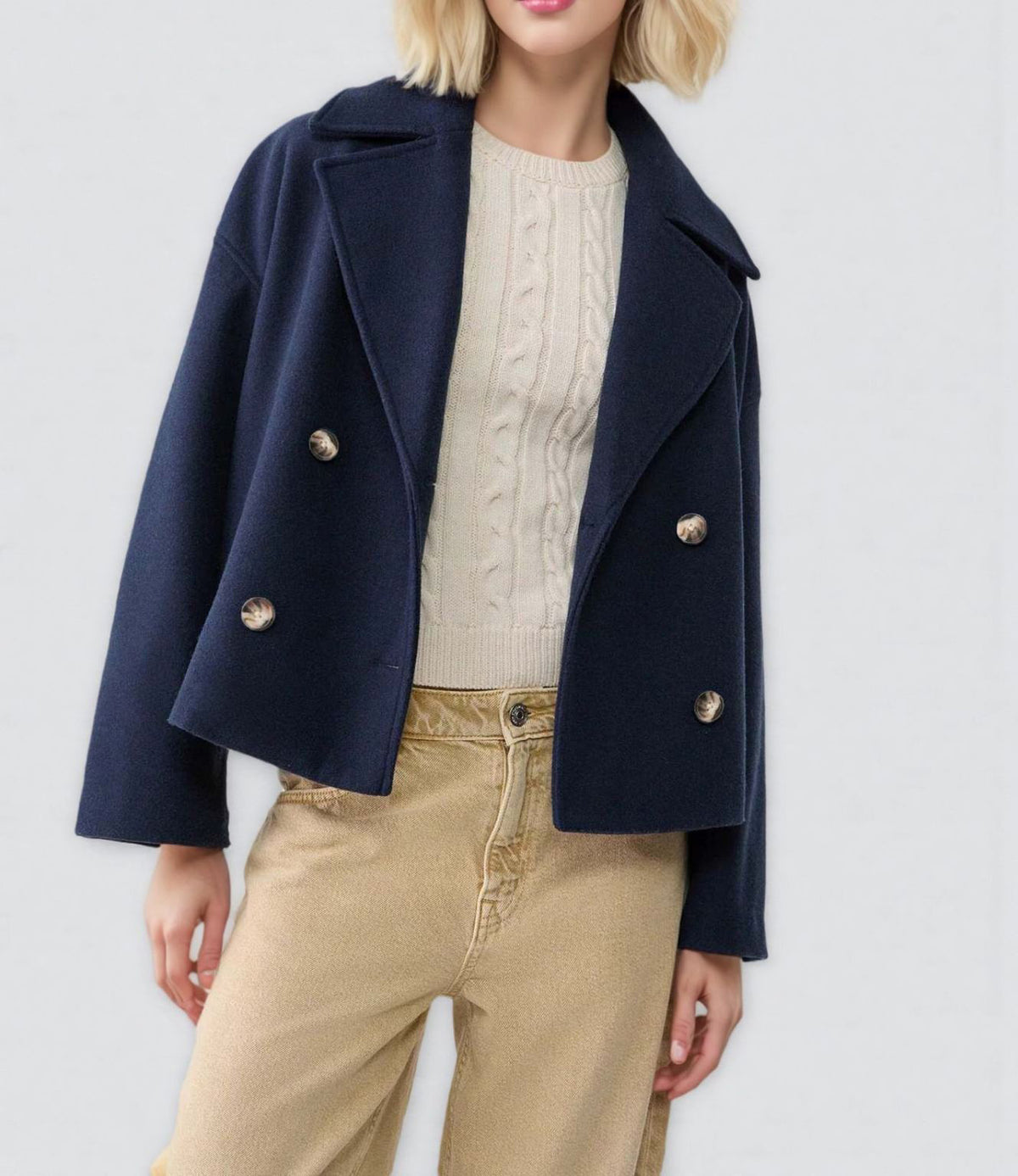 Close view of the notch lapel and double breasted button front of the wool coat