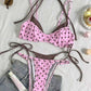 Brown polka dot bikini flat lay with blue dots and binding, triangle top and tie side brief