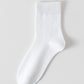 White bamboo viscose blend mid calf sock laid flat on a pale background